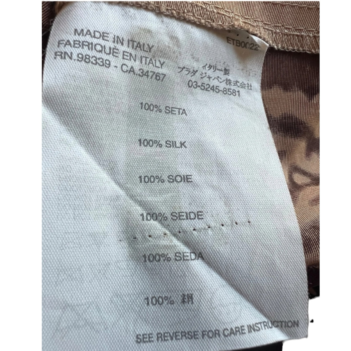 Fivedotsvintage Prada skirt care label showing 100% silk composition and Made in Italy authenticity details