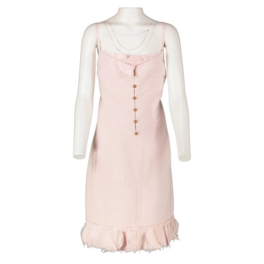 Fivedotsvintage Chanel pastel pink tweed mini dress with spaghetti straps, gold CC buttons, and a ruffled hem.