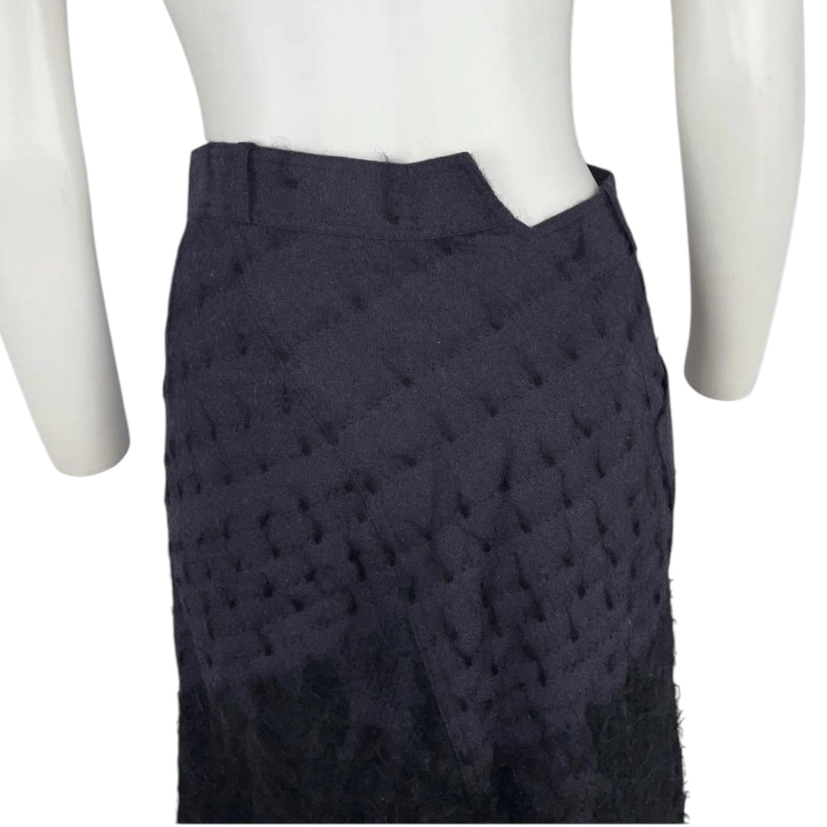 Fivedotsvintage Christian Dior black textured asymmetrical midi skirt with a structured waistband on a mannequin