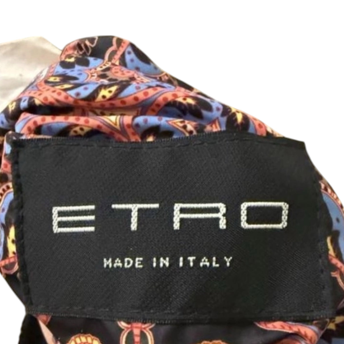 Fivedotsvintage ETRO jacket label featuring a vibrant paisley pattern in orange and blue on high-quality fabric.