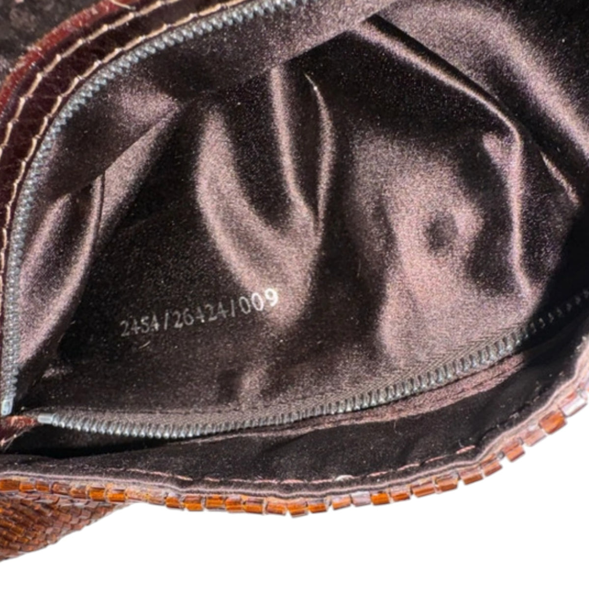 Fivedotsvintage FENDI beaded shoulder bag interior showing smooth brown fabric lining and serial number tag