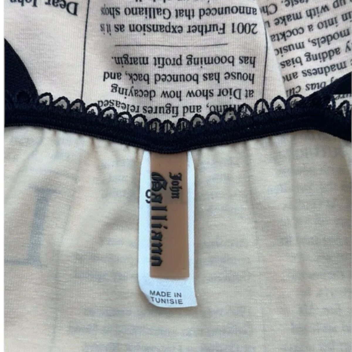 Fivedotsvintage John Galliano newspaper print mini dress label detail with black lace trim and Tunisia origin tag