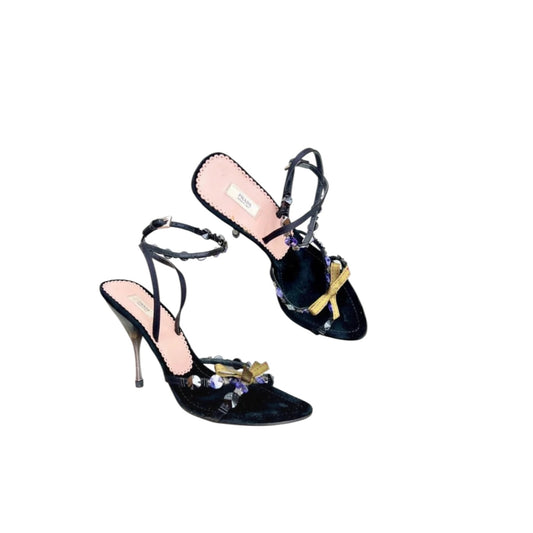 Fivedotsvintage Prada black velvet stiletto sandals with gold bows and crystal embellishments on an ankle strap.