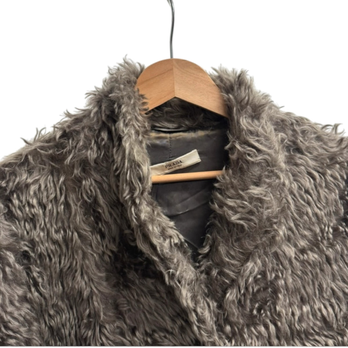 Fivedotsvintage PRADA charcoal grey faux fur coat with shaggy texture on a wooden hanger