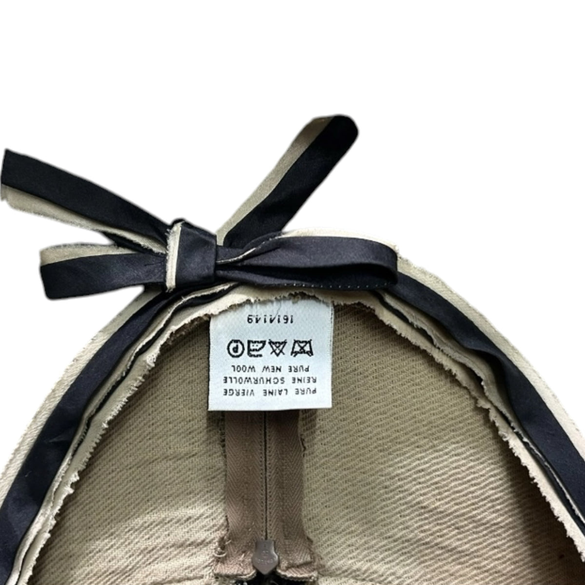 Fivedotsvintage Prada wool dress interior label with black bow detail and pure new wool care instructions