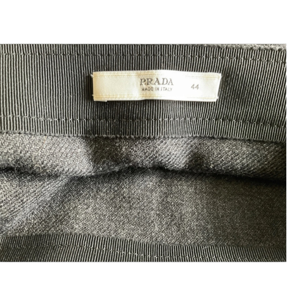 Fivedotsvintage Prada charcoal wool mini skirt interior label showing size 44 and Made in Italy branding
