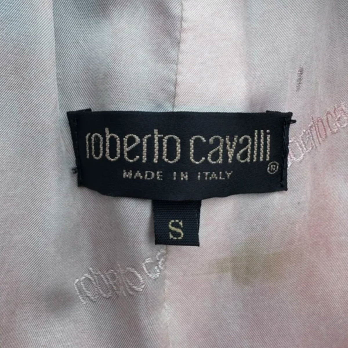 Fivedotsvintage Roberto Cavalli designer clothing label in black with white text and size S tag on light fabric