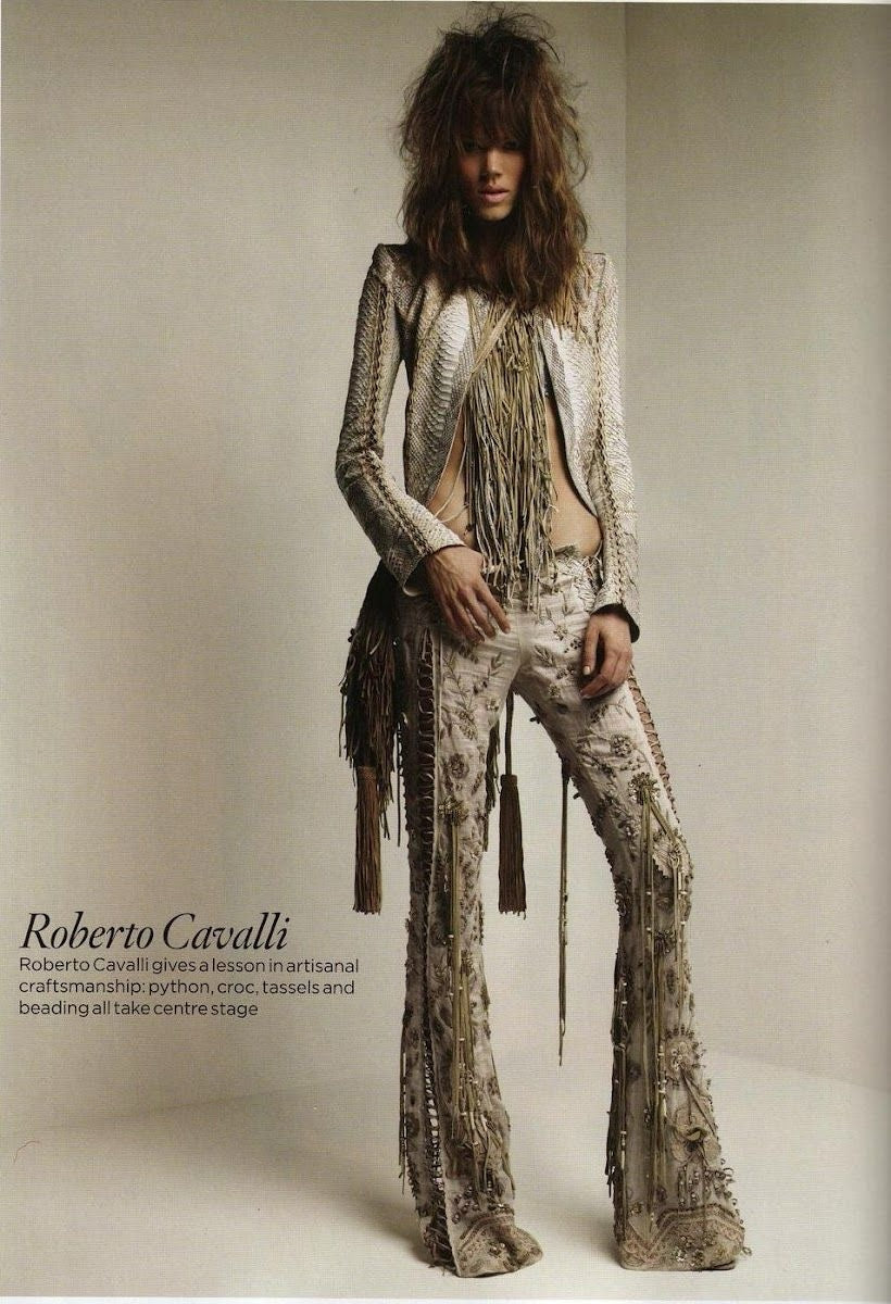 Fivedotsvintage model wearing a Roberto Cavalli snakeskin-effect jacket and embellished trousers with long tassels.